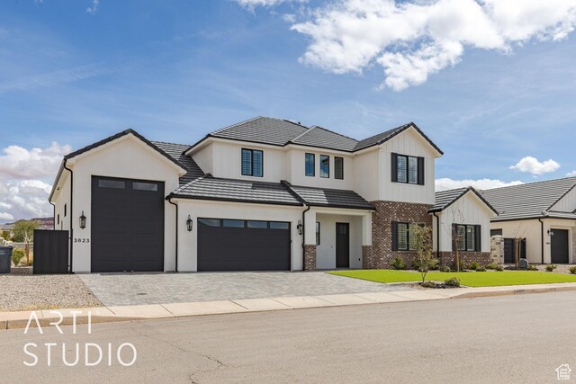 3823 S Kennedy Ln, Washington, UT 84780 - view of front of property with decorative driveway, an attached garage, stucco siding, and a tiled roof