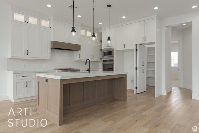 3823 S Kennedy Ln, Washington, UT 84780 - kitchen featuring a sink, stainless steel appliances, light wood-style floors, white cabinets, and light countertops