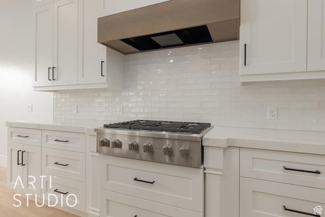 3823 S Kennedy Ln, Washington, UT 84780 - kitchen with custom exhaust hood, backsplash, stainless steel gas cooktop, and white cabinetry