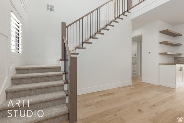 3823 S Kennedy Ln, Washington, UT 84780 - stairs featuring visible vents, a high ceiling, baseboards, and wood finished floors