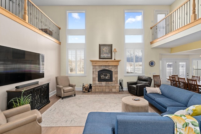 5798 W 11350 N, Highland, UT 84003 - living area with wood finished floors, plenty of natural light, a high ceiling, and a tile fireplace