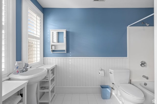 5798 W 11350 N, Highland, UT 84003 - bathroom with toilet, bathing tub / shower combination, a wainscoted wall, and tile patterned flooring
