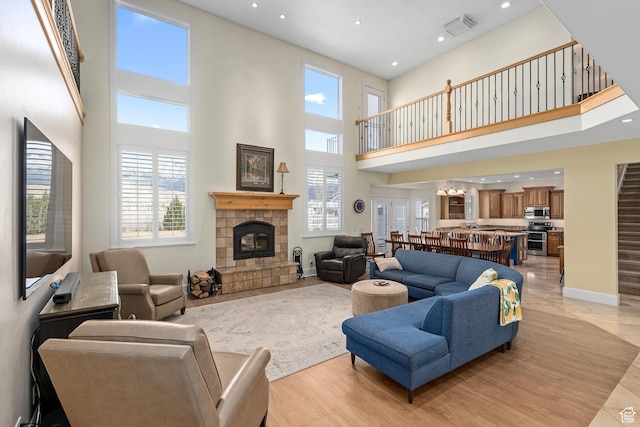 5798 W 11350 N, Highland, UT 84003 - living area with a towering ceiling, visible vents, recessed lighting, a tile fireplace, and baseboards