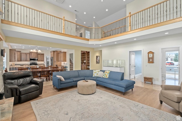 5798 W 11350 N, Highland, UT 84003 - living room featuring light wood-style floors, visible vents, recessed lighting, a high ceiling, and baseboards