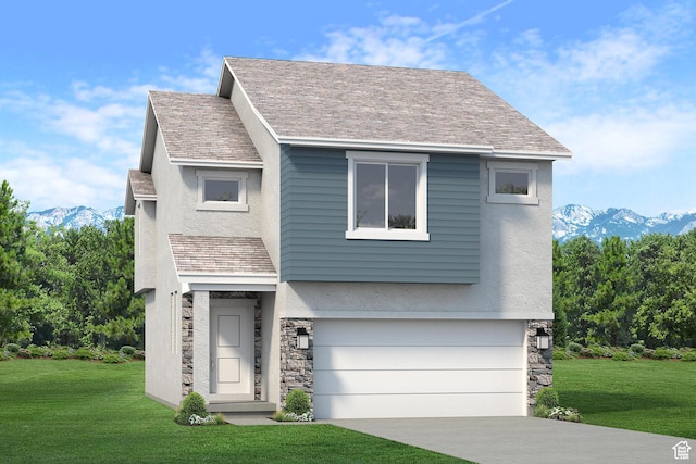 view of front of home with a mountain view, an attached garage, and a front lawn