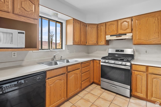 252 Hillside Dr, Moab, UT 84532 - kitchen with white microwave, under cabinet range hood, stainless steel range with gas stovetop, dishwasher, and a sink