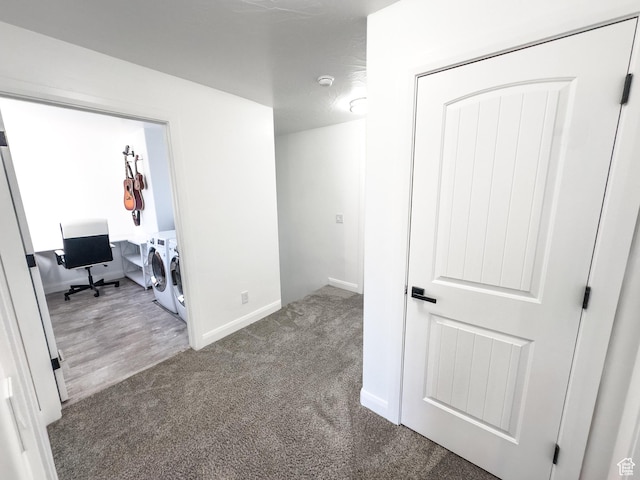 interior space with washer and dryer, baseboards, and carpet