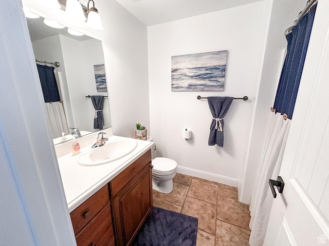 full bath with tile patterned flooring, toilet, vanity, and baseboards