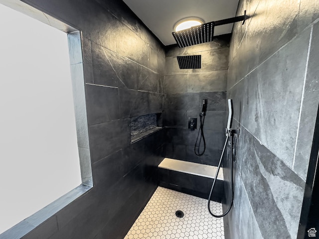 bathroom featuring tile patterned floors and a tile shower