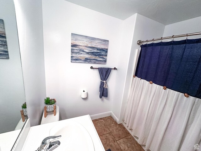 bathroom with tile patterned floors, baseboards, and a shower with curtain