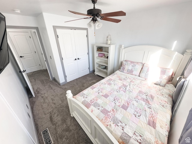 bedroom with visible vents, dark carpet, a closet, baseboards, and ceiling fan
