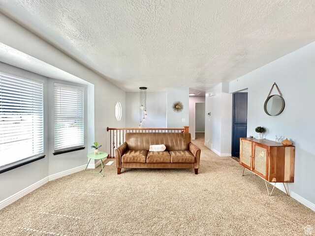 2964 W 5775 S, Roy, UT 84067 - living room featuring a textured ceiling, light colored carpet, and baseboards