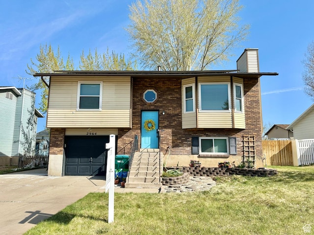 2964 W 5775 S, Roy, UT 84067 - raised ranch with fence, a front yard, a chimney, an attached garage, and driveway