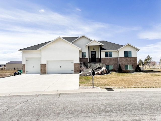 view of front of home with brick siding, driveway, an attached garage, and a front lawn