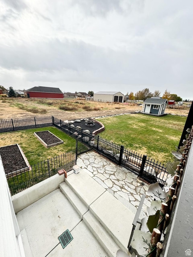 5517 S 6800 W, Hooper, UT 84315 - view of patio featuring an outbuilding, a vegetable garden, and fence