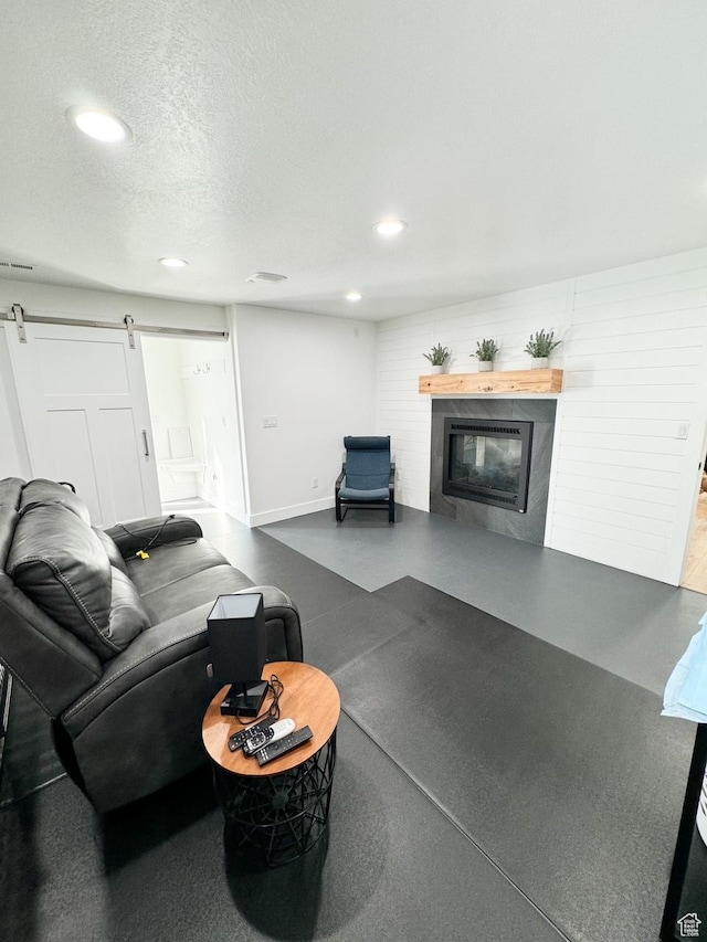 5517 S 6800 W, Hooper, UT 84315 - living area with recessed lighting, finished concrete floors, a textured ceiling, a glass covered fireplace, and a barn door