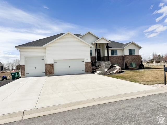 5517 S 6800 W, Hooper, UT 84315 - single story home with a garage, brick siding, concrete driveway, and a front yard