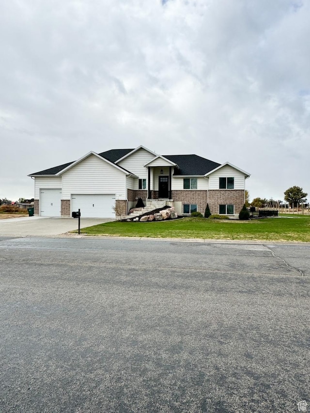 5517 S 6800 W, Hooper, UT 84315 - view of front of home featuring brick siding, a garage, driveway, and a front yard