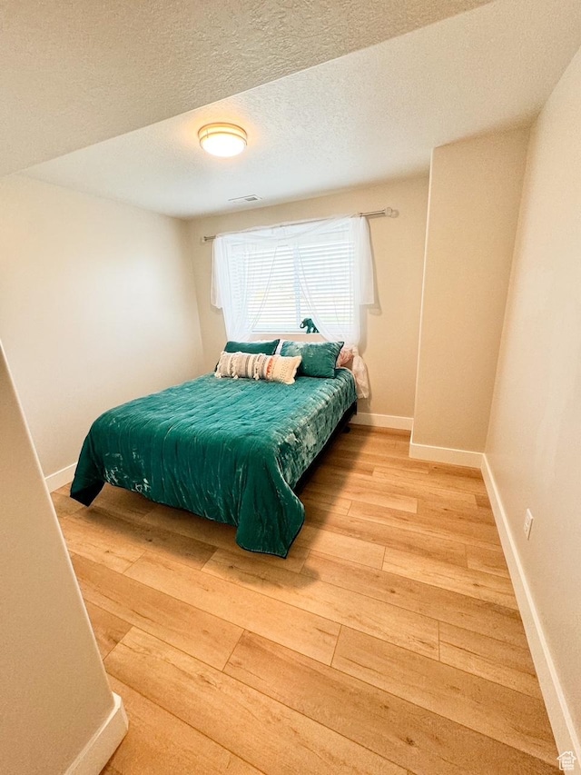 5517 S 6800 W, Hooper, UT 84315 - bedroom featuring light wood-style flooring, baseboards, and a textured ceiling