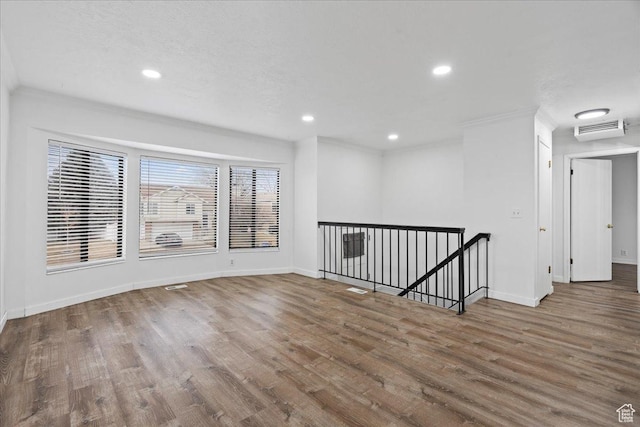 unfurnished room featuring visible vents, recessed lighting, baseboards, and wood finished floors