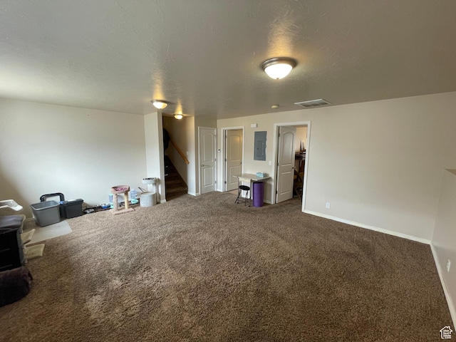 763 S 1500 W, Logan, UT 84321 - unfurnished living room featuring visible vents, stairs, electric panel, a textured ceiling, and dark colored carpet