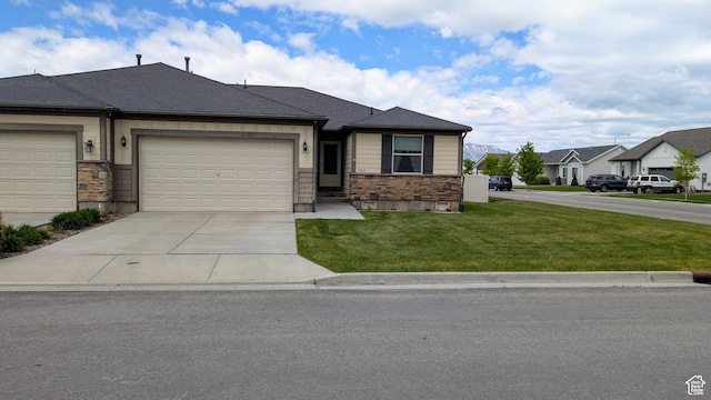 342 S 1250 E, Hyrum, UT 84319 - view of front of home featuring stone siding, a front yard, driveway, a garage, and a residential view