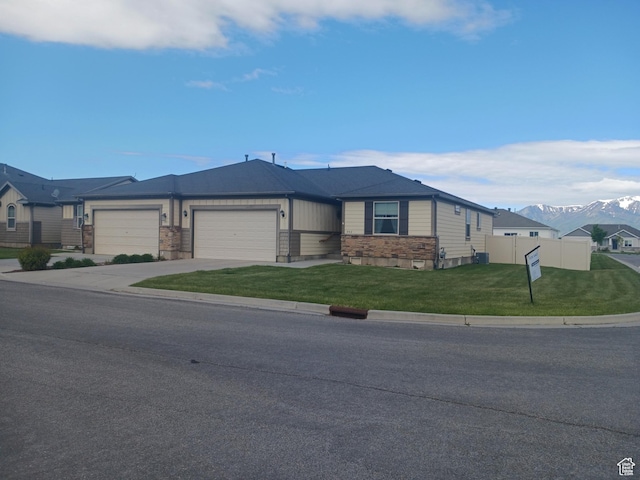 342 S 1250 E, Hyrum, UT 84319 - view of front of house with an attached garage, driveway, a mountain view, and stone siding