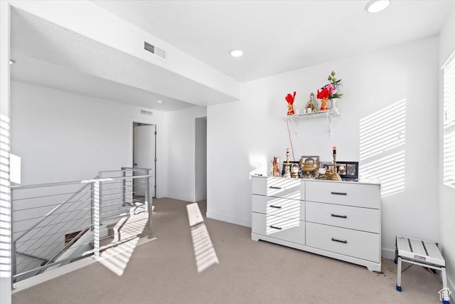 interior space featuring recessed lighting, visible vents, light colored carpet, and baseboards
