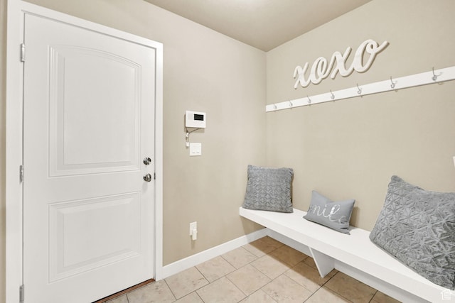 mudroom featuring light tile patterned floors and baseboards