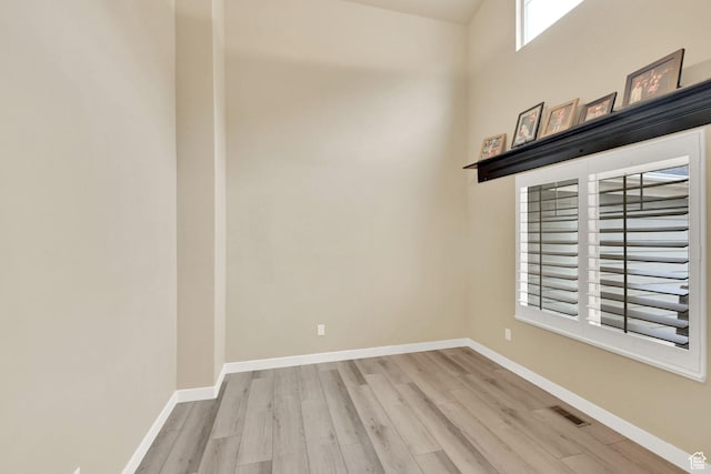 unfurnished room with visible vents, baseboards, and wood finished floors