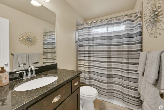 bathroom with vanity, a shower with shower curtain, toilet, and tile patterned floors