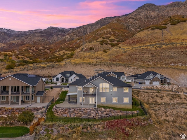 aerial view at dusk with a mountain view and a residential view