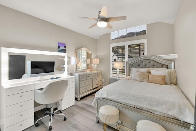 bedroom featuring lofted ceiling, light wood-style floors, and ceiling fan