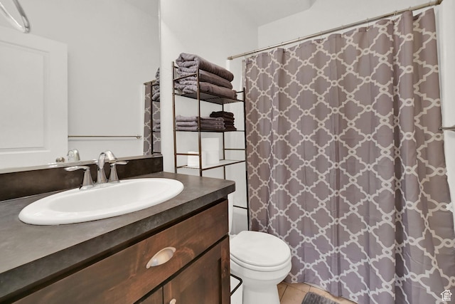 bathroom with vanity, tile patterned floors, toilet, and a shower with curtain