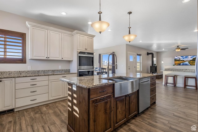 2409 W Rim Rock Dr, Stockton, UT 84071 - kitchen featuring a sink, stainless steel appliances, dark wood-type flooring, and white cabinets