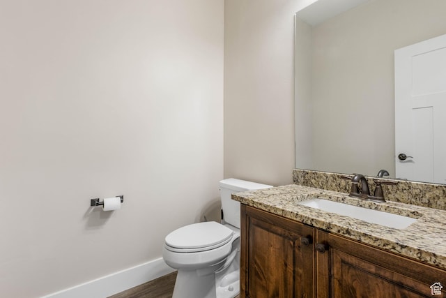 2409 W Rim Rock Dr, Stockton, UT 84071 - bathroom featuring baseboards, toilet, wood finished floors, and vanity