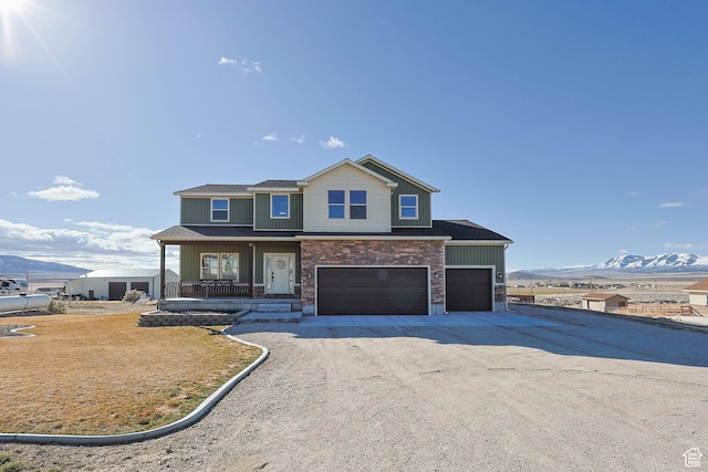 2409 W Rim Rock Dr, Stockton, UT 84071 - view of front of property featuring a front yard, driveway, a porch, an attached garage, and a mountain view