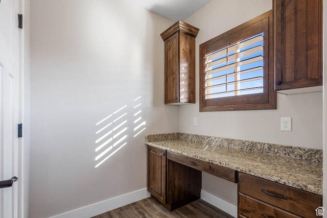 2409 W Rim Rock Dr, Stockton, UT 84071 - unfurnished office with dark wood finished floors, baseboards, and built in desk