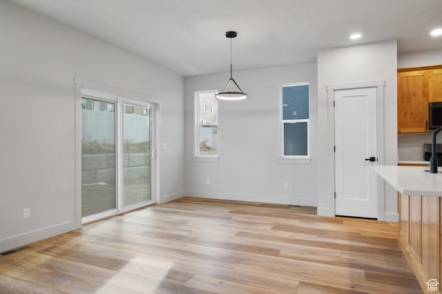 6317 W Cape Ridge Ln, West Valley City, UT 84128 - unfurnished dining area featuring recessed lighting, baseboards, visible vents, and light wood finished floors