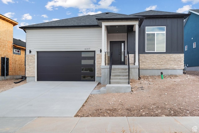 6317 W Cape Ridge Ln, West Valley City, UT 84128 - view of front of property with driveway, an attached garage, board and batten siding, and stone siding