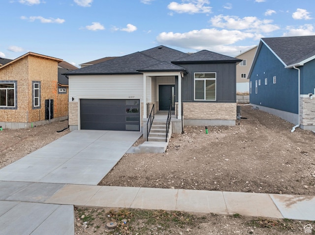 6317 W Cape Ridge Ln, West Valley City, UT 84128 - view of front of home featuring an attached garage, driveway, and a shingled roof