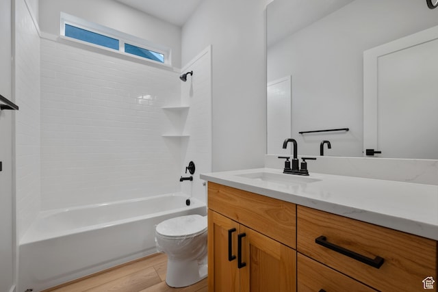 6317 W Cape Ridge Ln, West Valley City, UT 84128 - bathroom featuring vanity, wood finished floors, toilet, and washtub / shower combination