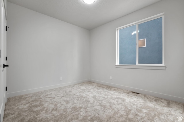 6317 W Cape Ridge Ln, West Valley City, UT 84128 - empty room featuring visible vents, baseboards, and carpet