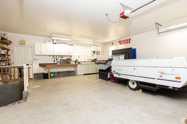 161 S Canyon Rd E, Parowan, UT 84761 - garage featuring a workshop area and a garage door opener