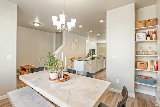 dining area with recessed lighting, baseboards, a chandelier, and light wood-style floors