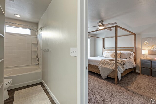 bathroom with baseboards, ceiling fan, toilet, and connected bathroom