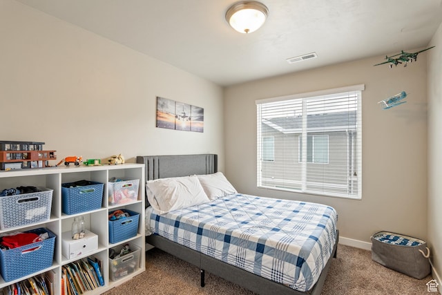 carpeted bedroom featuring baseboards and visible vents