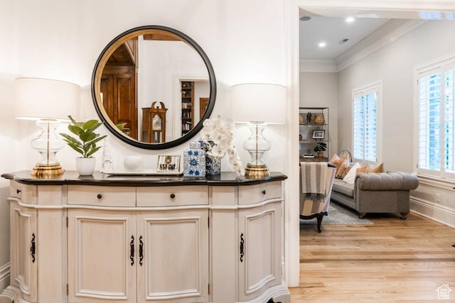 bathroom featuring baseboards, ornamental molding, recessed lighting, wood finished floors, and vanity