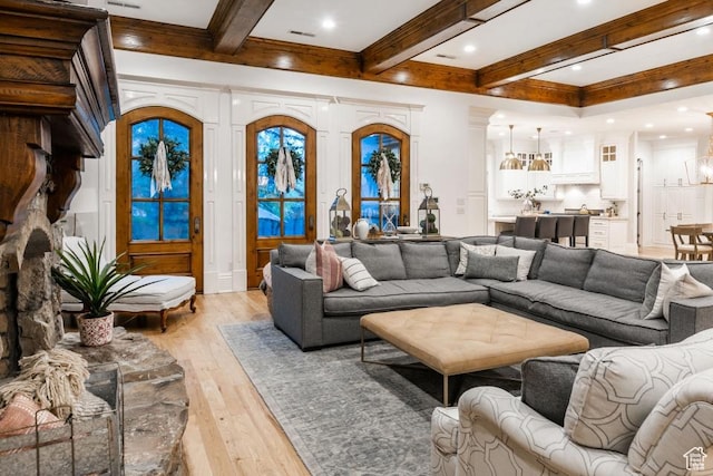 living room with beamed ceiling, recessed lighting, and light wood-style floors