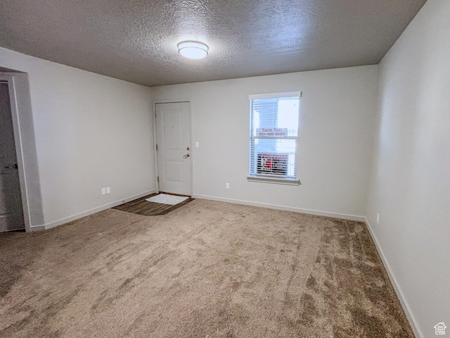 1700 S Sandhill Unit H203, Orem, UT 84058 - unfurnished room with baseboards, carpet, and a textured ceiling